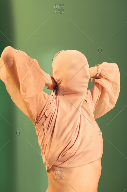 Woman covering her face with her blouse