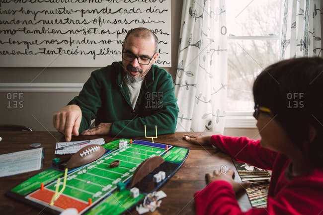 Father playing a tabletop football game with his son