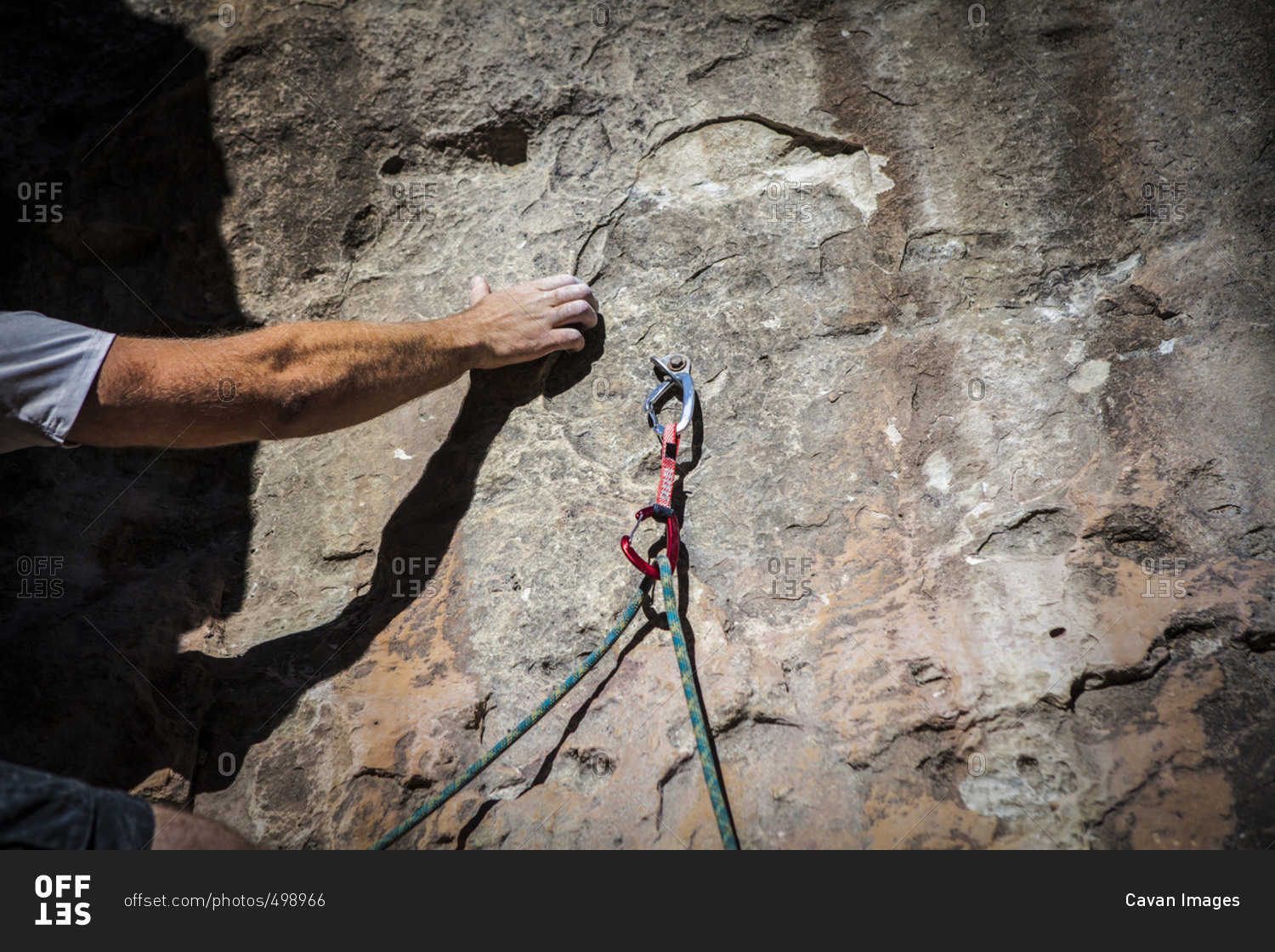 Cropped image of hand gripping while rock climbing