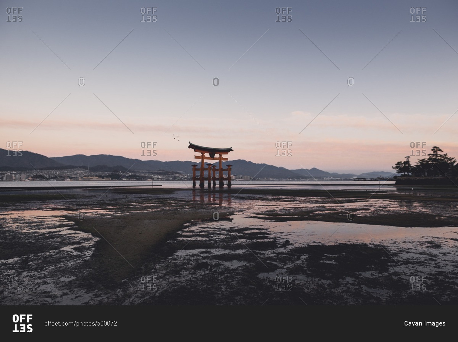Tori gate in lake during sunset