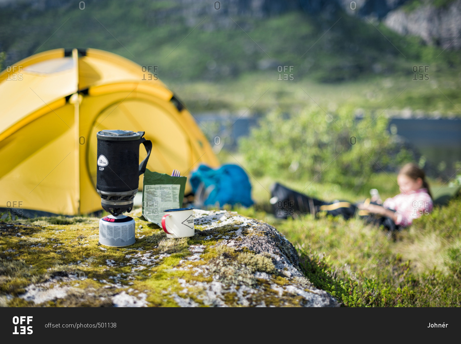Camping stove, tent and girl on background