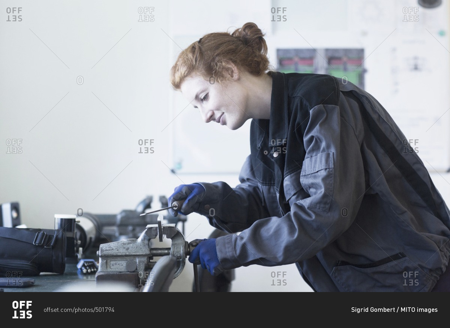 Young female engineer using vise grip tool in an industrial plant, Freiburg im Breisgau, Baden-Wurttemberg, Germany