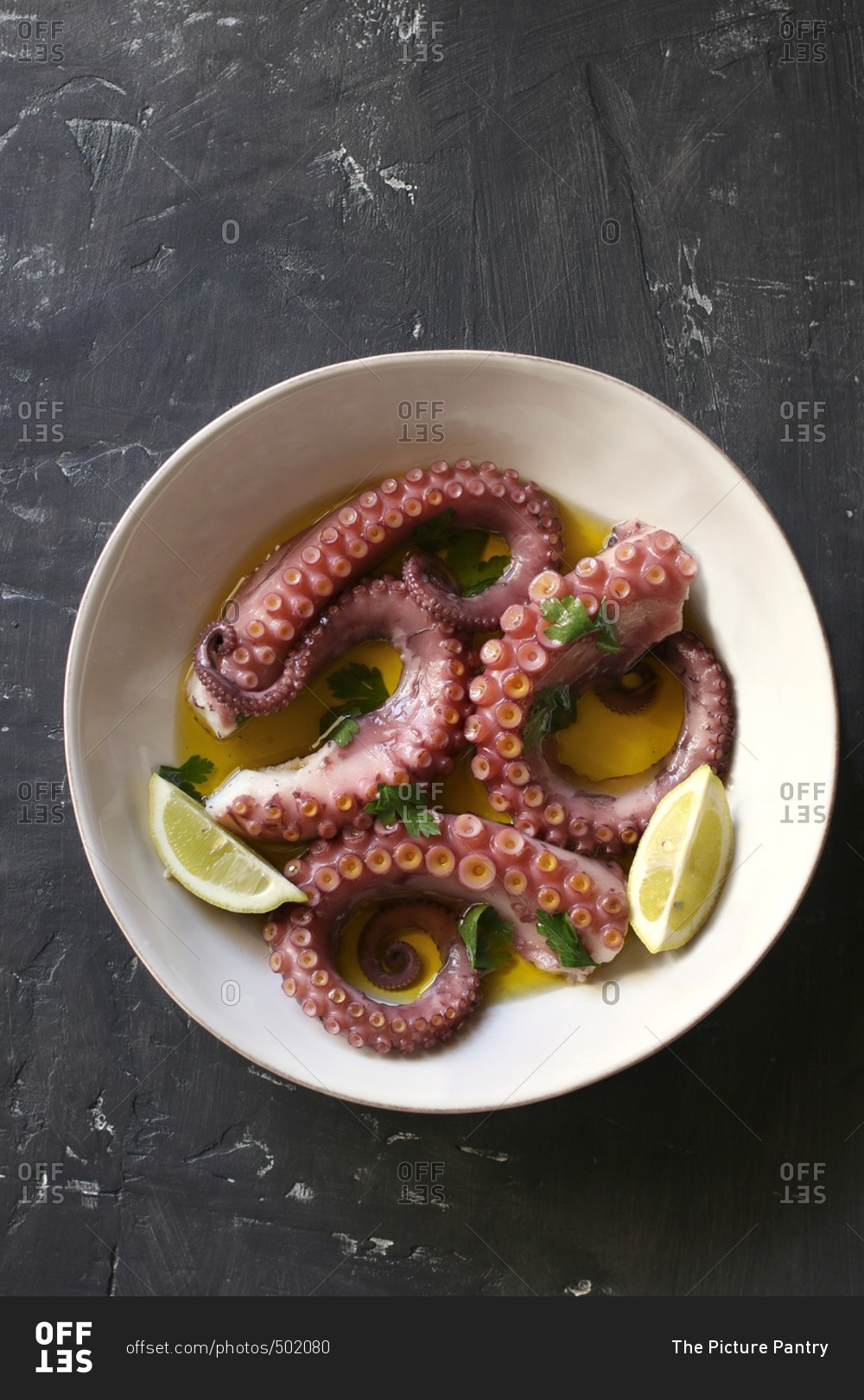 Portuguese cooked octopus with olive oil, garlic and parsley