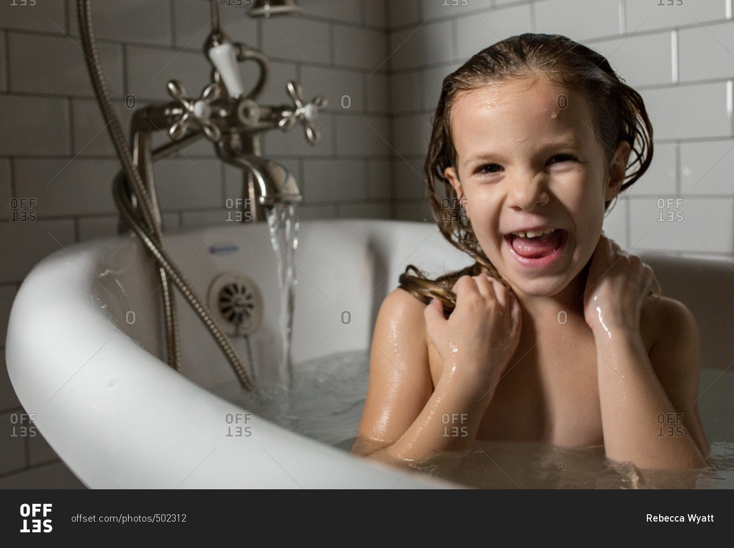 Little girl taking a bath stock photo - OFFSET