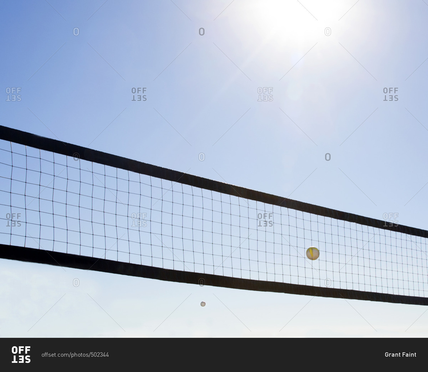 Volleyball net and ball in flight