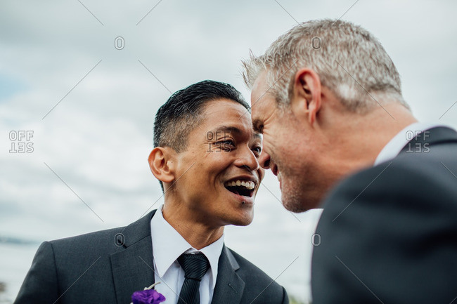 Grooms laughing in loving stare