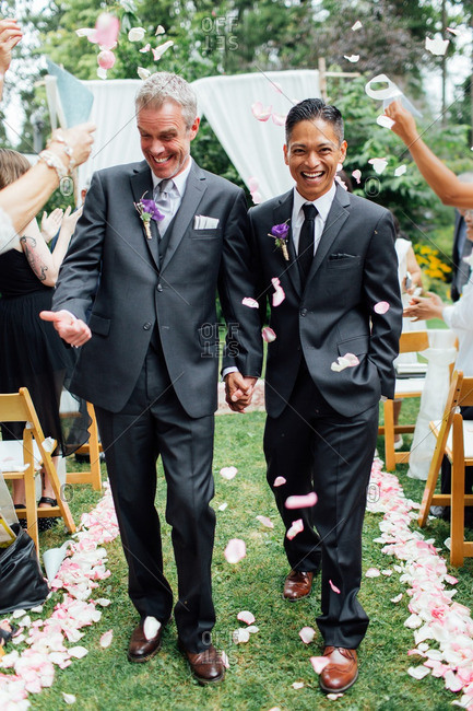 Grooms walking aisle after ceremony