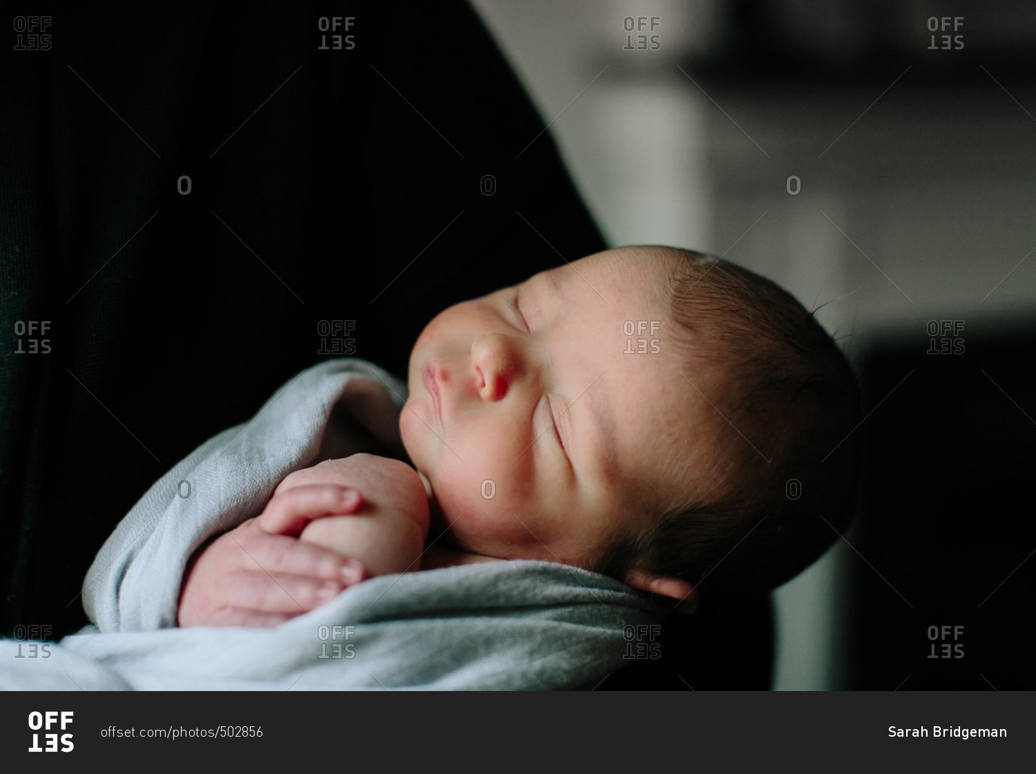 sleeping-baby-in-adult-s-arms-stock-photo-offset