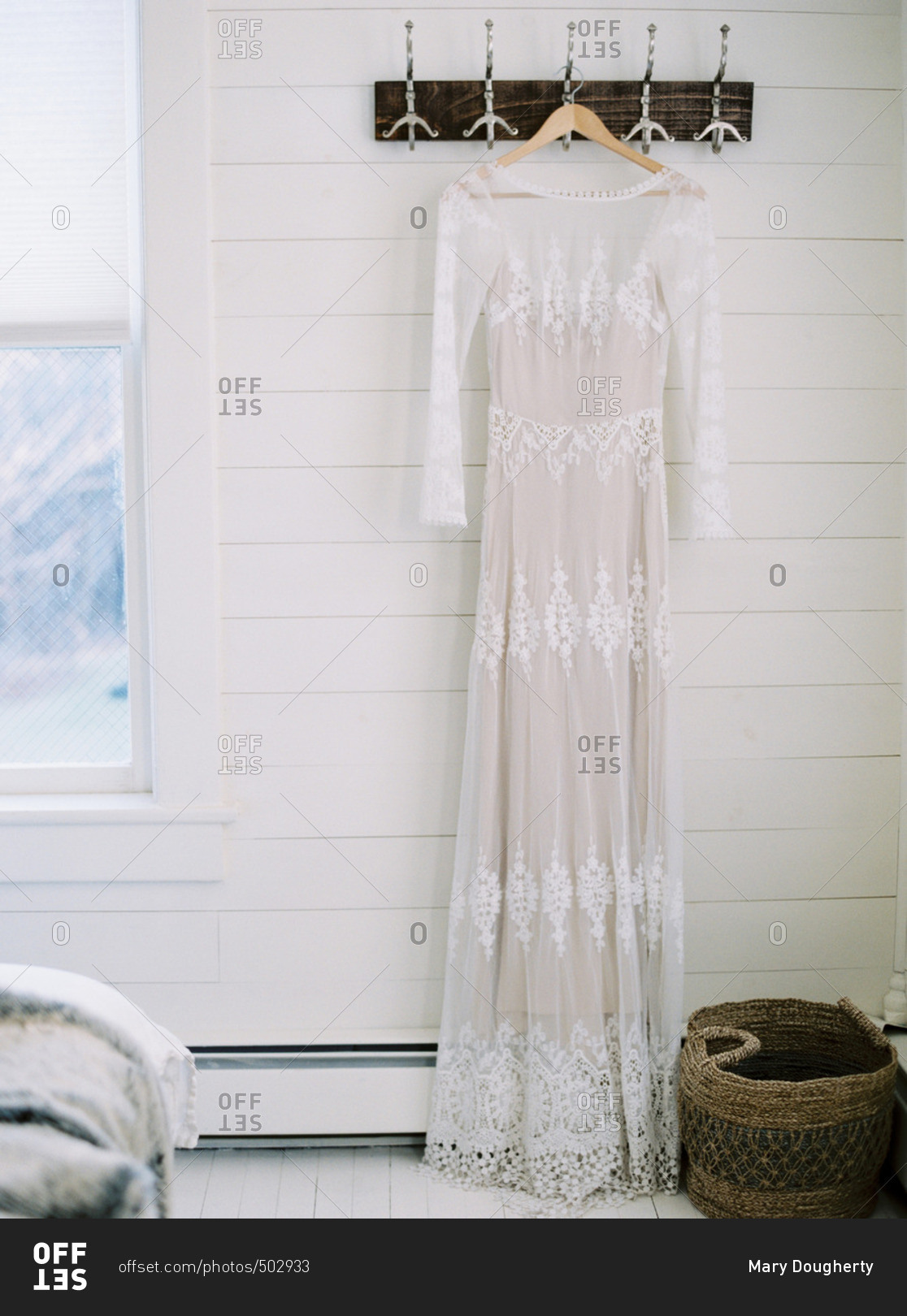 Wedding dress hanging from hooks on a wall
