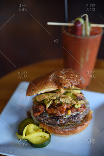Burger served with a bloody Mary in a restaurant
