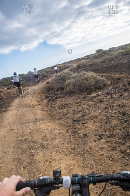 Four people biking on desert trail