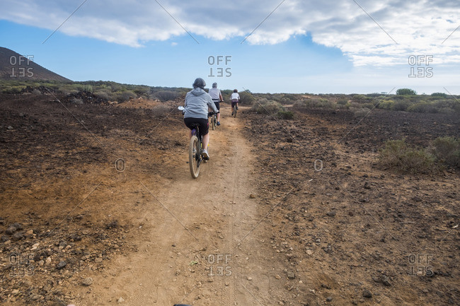 Three people biking on desert trail