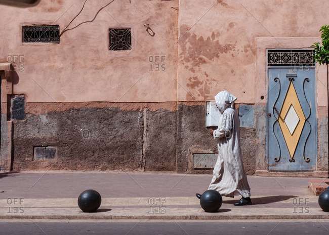 4/4/15: Arab man in traditional clothing, walking on a street in Marrakesh