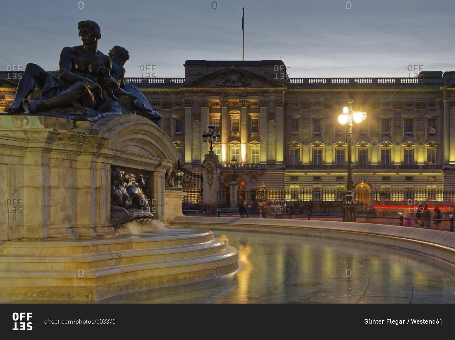 UK- London- lighted Buckingham Palace at dusk with fountain in the foreground
