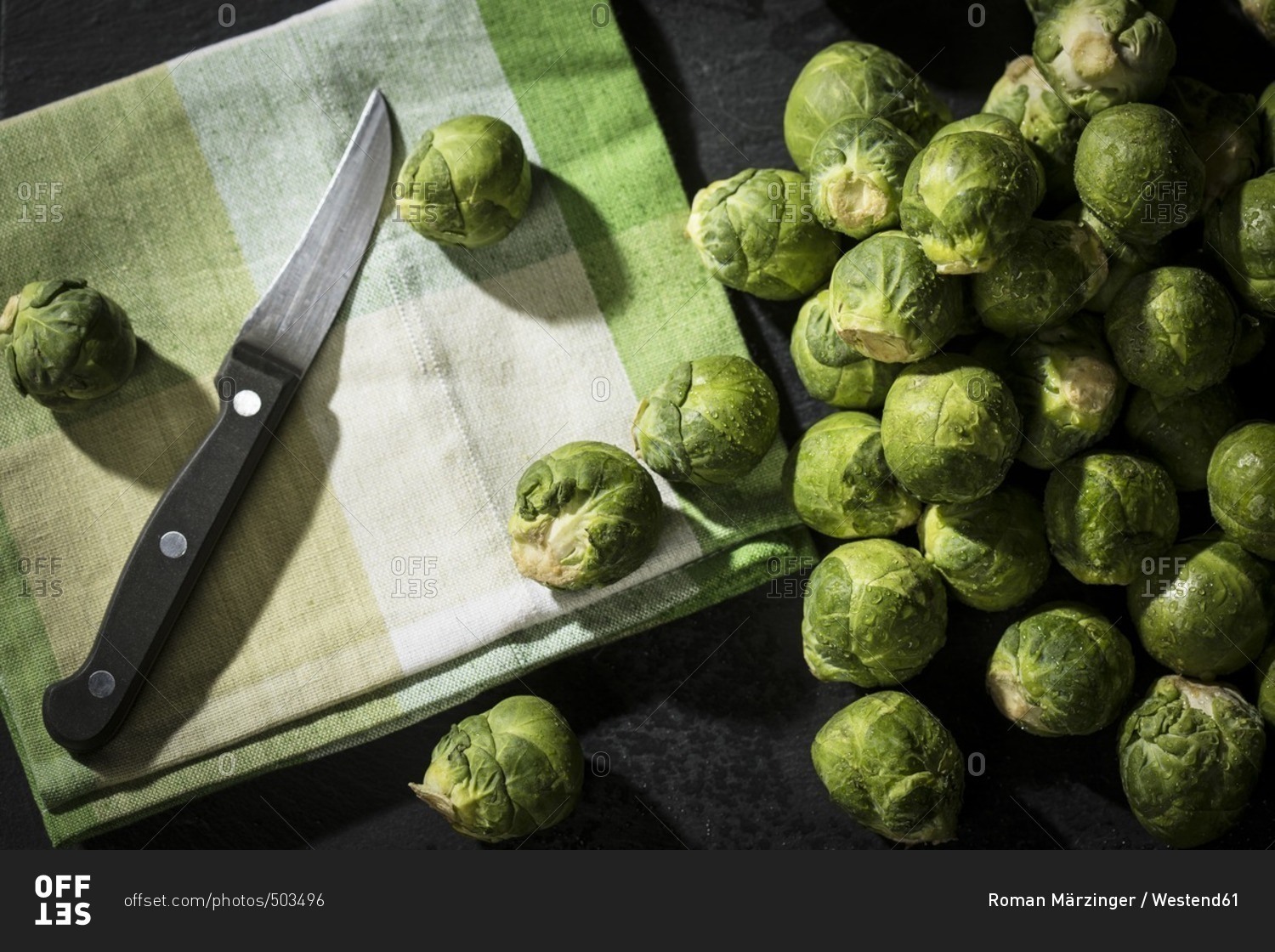 Brussels sprouts- cloth and kitchen knife on slate