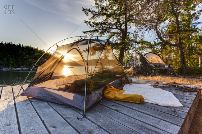 The sun sets through a kayaker's tent on West Curme Island Desolation Sound Marine Park, British Columbia, Canada