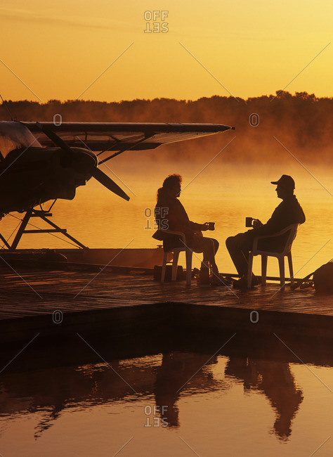 Manitoba, Canada - March 19, 2013: A couple relaxes on a float plane dock