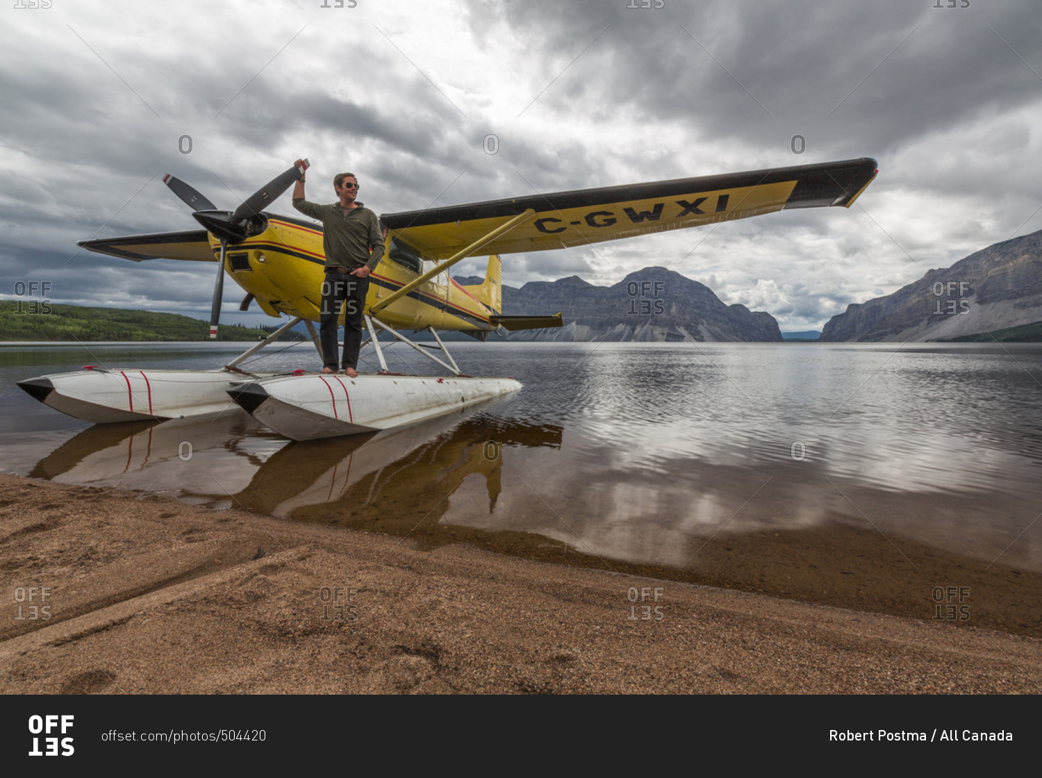 Northwest Territories, Canada July 5, 2013 Float plane pilot standing on the floats at Little