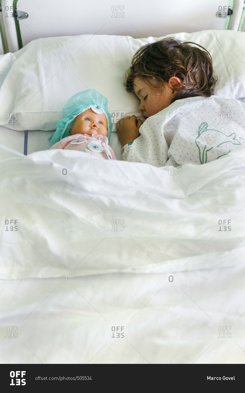 Little girl in a hospital bed stock photo OFFSET