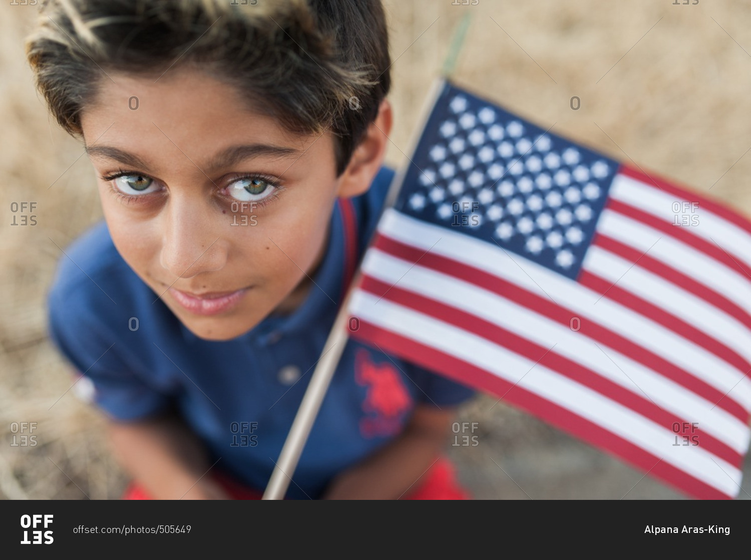 Close up of a young boy holding American flag