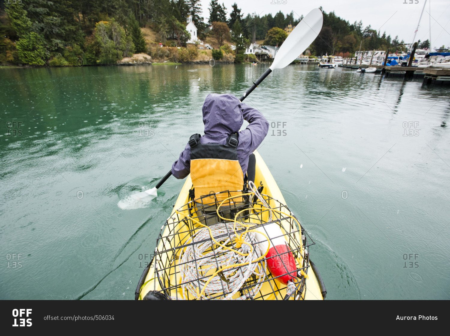 A girl kayaks through roche harbor, san juan island, Washington