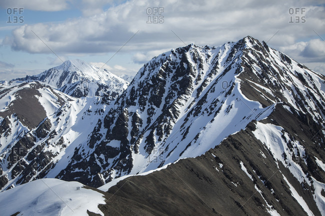 Distant view of people hiking on king's throne in Yukon
