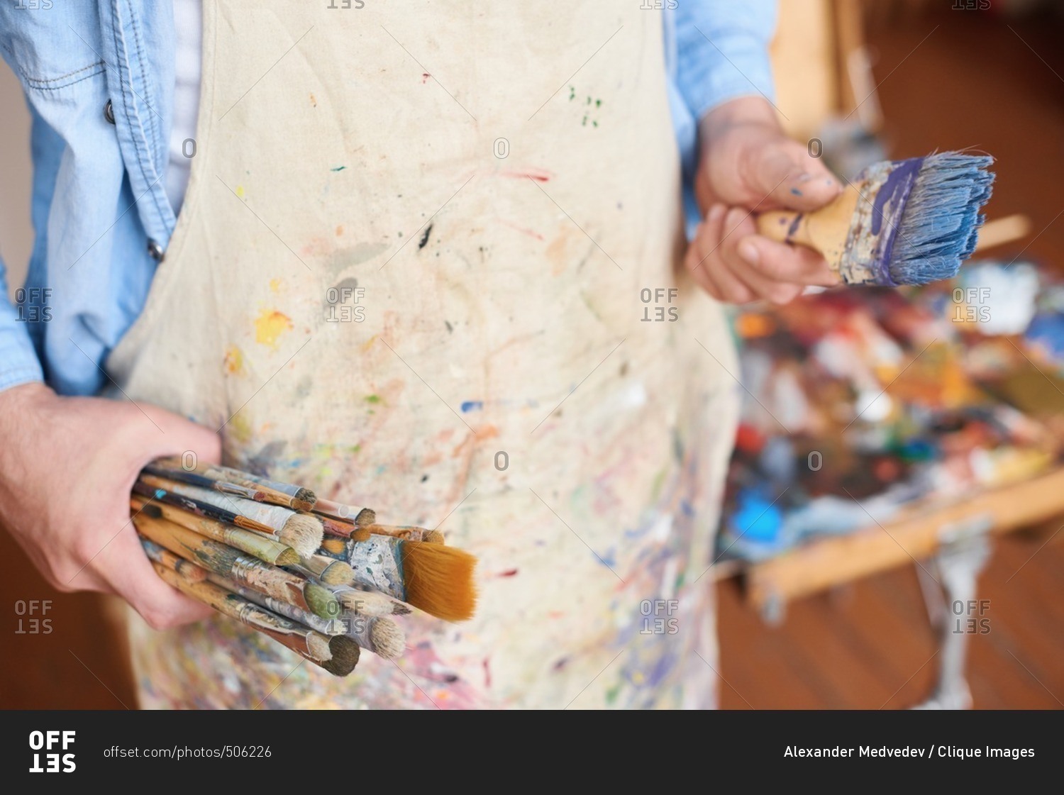 Getting ready for painting. Male artist in stained apron standing with