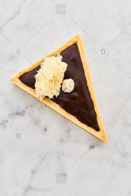 Triangle Shape Slice Piece Of Chocolate Fudge Cake Decorated With Chocolate  Curl On Plate With White Isolated And Clipping Paths Delicious And Soft  Sweet And Bitter Homemade Bakery Concept Stock Photo -