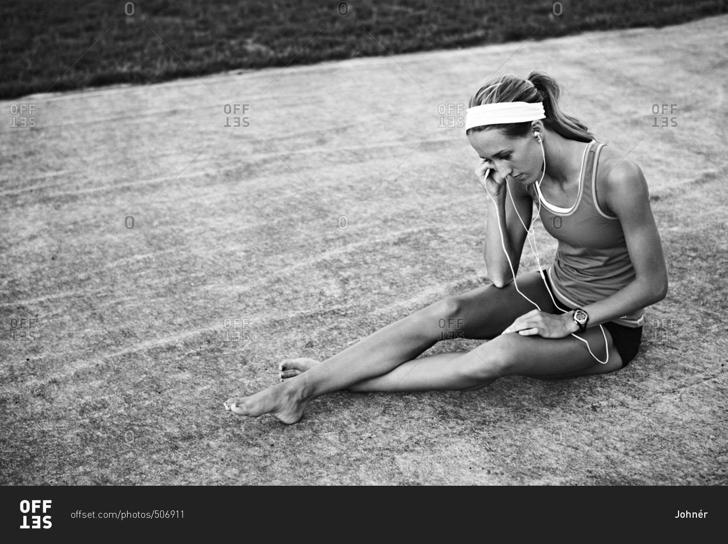 Young woman listening to music on sports track