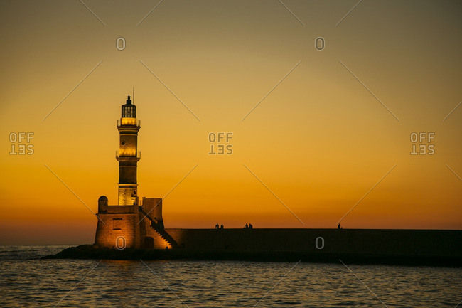Illuminated lighthouse at sunset - Offset
