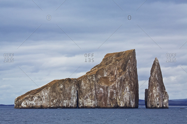 Eroded islet and rock stack at sea in Galapago