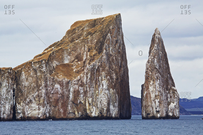 Eroded islet and rock stack at sea in Galapagos