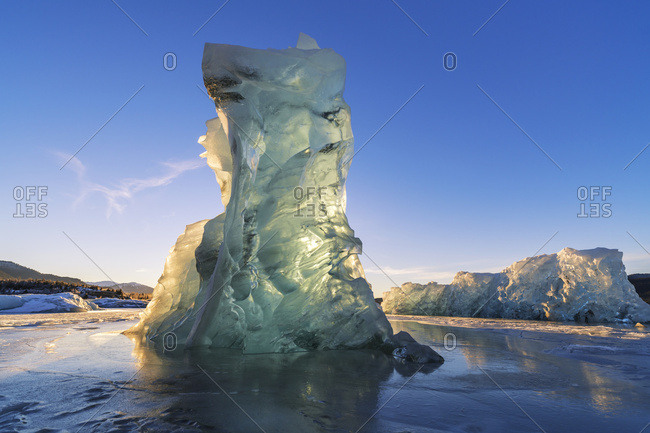 An iceberg glows with the light from the setting sun, Mendenhall Lake, Tongass National Forest; Juneau, Alaska, United States of America