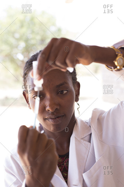 Doctor preparing a syringe for immunization at a clinic in Africa