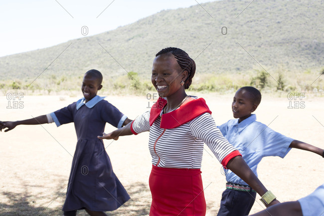 Teacher with children doing outdoor activities, Kenya