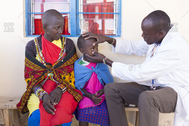 Doctor examining Maasai child, Kenya, Africa