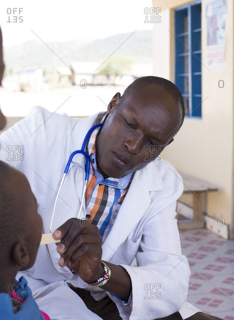 Doctor examining child in Maasai child, Kenya, Africa