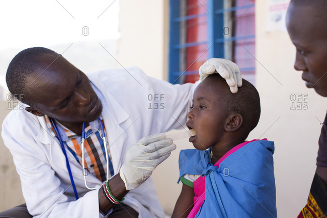 Doctor examining young girl from the Maasai tribe, Kenya