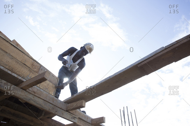 Man working on construction site, Kenya, Africa