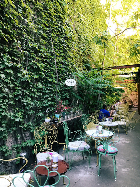 Buenos Aires, Argentina - January 12, 2017: Outdoor cafe by vine covered wall