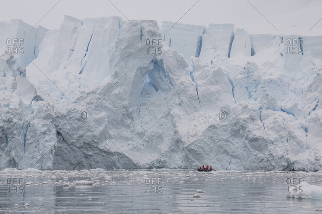 A Zodiac cruises near a glacier face in Paradise Bay, Antarctica