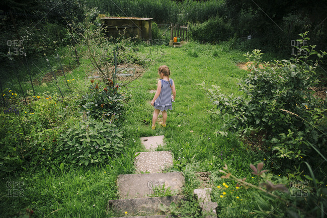 Girl exploring a rural yard