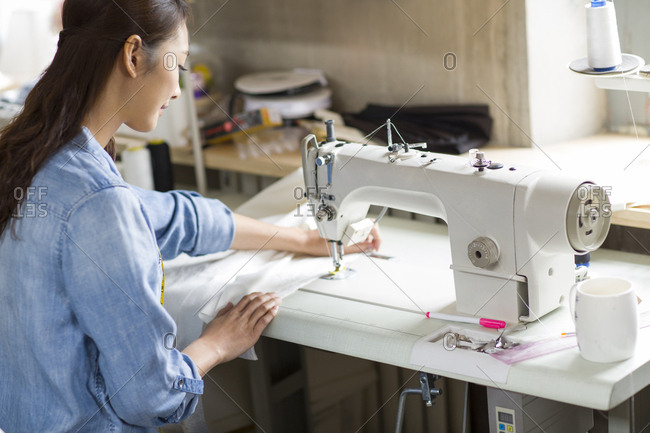 Fashion designer using sewing machine