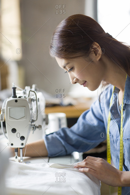 Fashion designer using sewing machine
