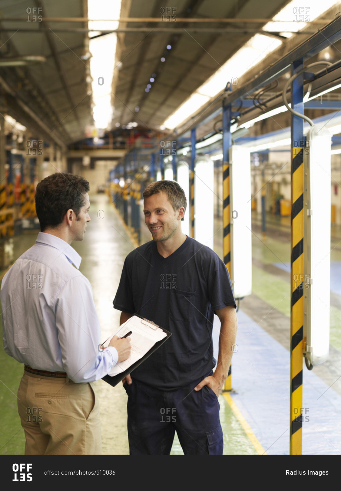 Men Talking in Automotive Plant