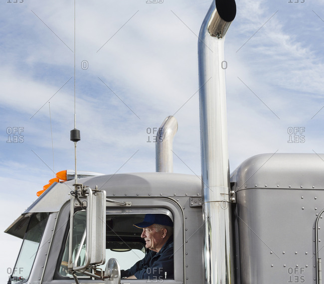Caucasian trucker driving semi-truck