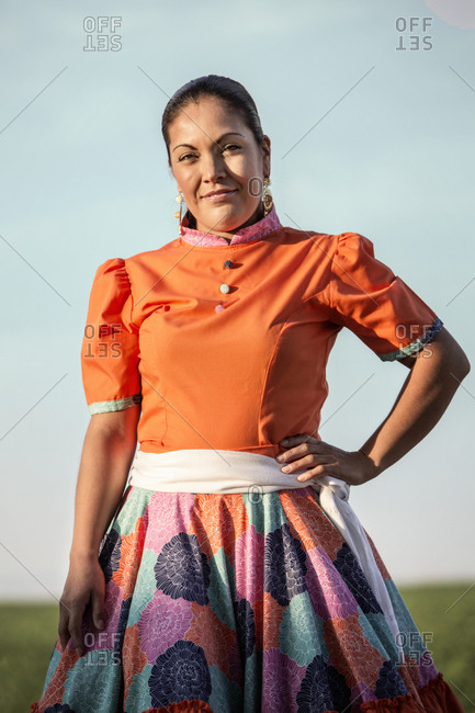 Hispanic woman in traditional garb outdoors