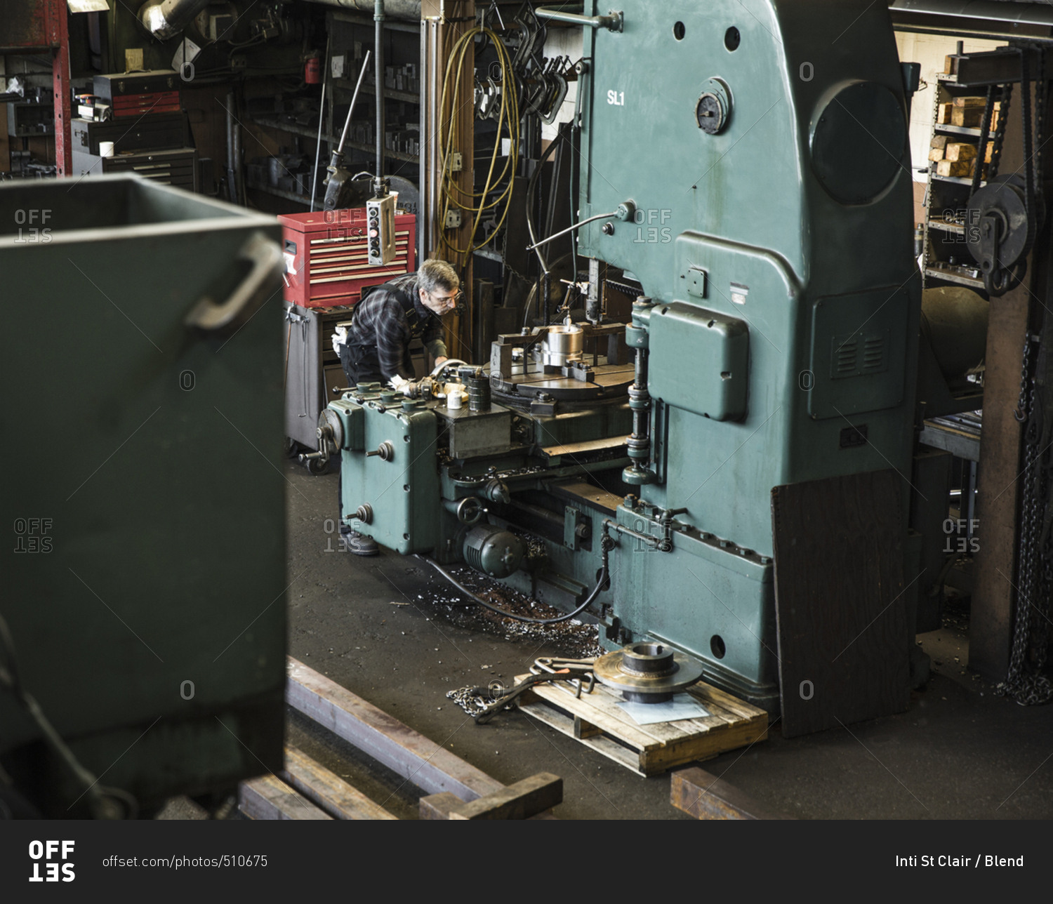 Caucasian man using machinery in workshop