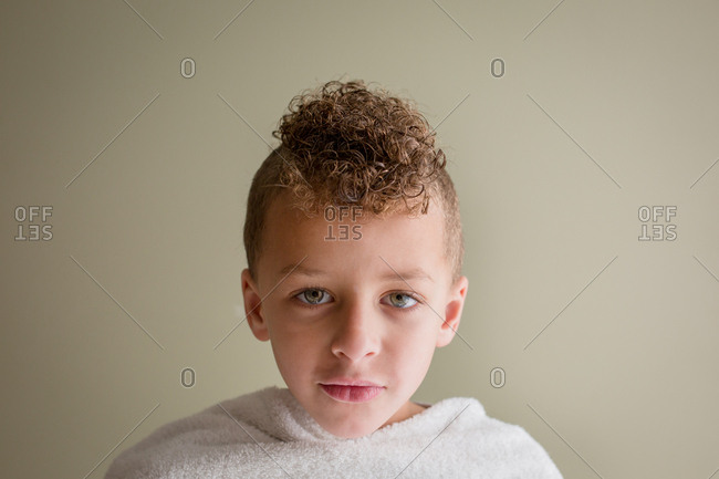Portrait Of A Boy With A Curly Haired Mohawk With A Towel