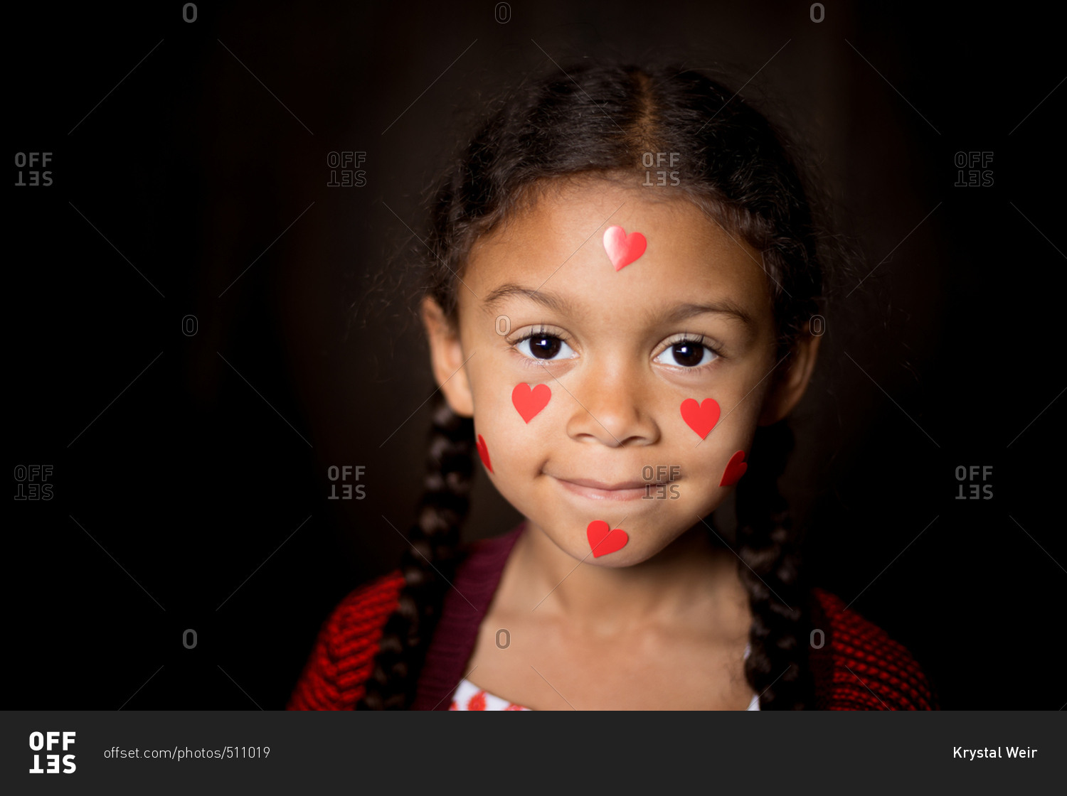 Girl covered in heart stickers